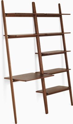 a wooden shelf with three shelves and two bookshelves on the top one is leaning against the wall