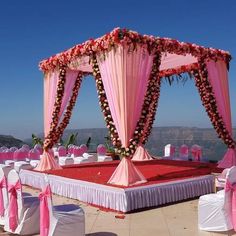 an outdoor wedding setup with pink and white decor