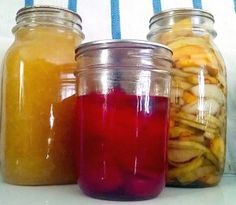 three jars filled with different types of fruit and veggies next to each other