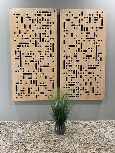 two pieces of wood with black and white designs on them sitting on a counter top