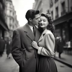 black and white photograph of a couple kissing on the street