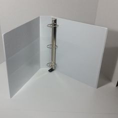 an open binder sitting on top of a white table