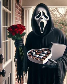 a man in a black robe holding a box of chocolates and a red rose