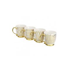 four coffee mugs with gold handles and designs on the sides, all lined up in a row