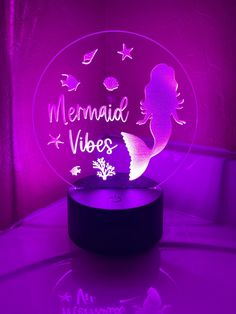 a purple light that says mermaid vibes on the front and back with an image of a mermaid under it