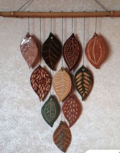 a group of leaf shaped ornaments hanging on a wall