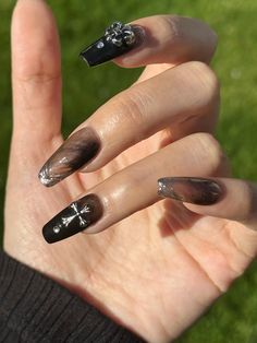 This nail art design combines the mystery of black with the modern touch of silver, showcasing a dark gothic style. The 3D cross and stripes on the nails add depth and visual impact, adding a unique charm to the overall look. This design is suitable for both everyday wear and can be paired with special occasion outfits, showcasing a blend of personality and fashion-forward allure. Every package contains 10 pcs well made press on nails, liquid glue, jelly glue, mini file and a wooden stick Gothic Nail Charms, Gothic Nails Square, Cross Gem Nails, Gothic Nails Black, Goth Wedding Nails, Clear Black Nails, Black 3d Nails, Cross Charm Nails, Charm Nail Designs