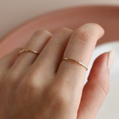 Stack up the beauty - simple, elegant rings forged from 14k solid gold. Choose between a smooth, polished look or hand hammered version. Or don't choose at all - order them both as a pair! Each purchase comes with an elegant, vegan leather box for storing + caring for your jewelry. DETAILS14k Solid GoldRing sizes 4-10 including half sizesSold as a single ring Elegant Everyday Solid Color Jewelry, Simple Hammered Ring Jewelry, Everyday 14k Gold Midi Rings, Everyday Midi Rings In 14k Gold, Elegant Hammered Stackable Rings, Classic Hammered Rose Gold Jewelry, Everyday 14k Gold Hammered Jewelry, Minimalist Hand Forged Gold Midi Rings, Elegant Hammered Midi Rings For Wedding