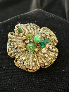 Meticulously Beaded Brooch with various shades of green rhinestones, some with clear swirls. Set on heavy filigree base. Signed Originals by Robert. Rare. Antique Green Brooch For Evening, Green Beaded Evening Jewelry, Vintage Green Brooch For Evening, Vintage Green Evening Brooches, Vintage Green Evening Brooch, Green Embellished Jewelry For Gifts, Vintage Green Brooch For Party, Green Brooch For Party, Unique Green Beaded Brooches