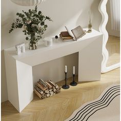 a white console table with books and candles