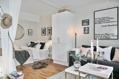 a living room filled with furniture and white walls