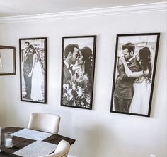 a dining room table with chairs and pictures on the wall