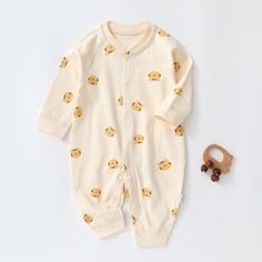 Be the cutest baby around in this Fun and Cozy Cartoon Bear Romper. This romper will keep your baby warm and cozy all day long while bringing a smile to everyone's face with its irresistibly cute design. Get ready to stand out from the crowd! Introducing the Unisex Cartoon Romper, designed for fun and comfort. Made from soft and breathable cotton, it's perfect for spring and autumn wear. Featuring a charming cartoon pattern, this romper adds a touch of cuteness to your baby's wardrobe. Equipped Playful Long Sleeve Onesie For Loungewear, Cotton Long Sleeve Onesie For Sleep, Cream Long Sleeve Onesie For Loungewear, Cream Cotton Onesie For Playtime, Cream Cotton Playtime Onesie, Cute Cartoon Print Onesie For Sleep, Cute Cartoon Print Sleep Onesie, Playful Long Sleeve Jumpsuits And Rompers For Playtime, Long Sleeve Onesie With Cartoon Print For Playtime