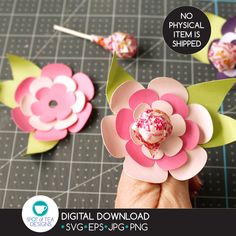 the paper flowers are being made to look like they have pink and green leaves on them