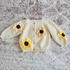 a knitted sweater with sunflowers on it