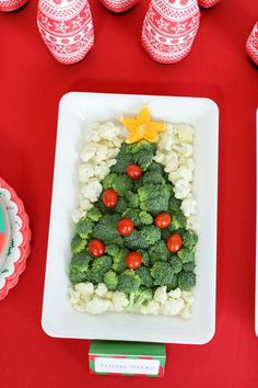 a christmas tree made out of broccoli and cauliflower on a table