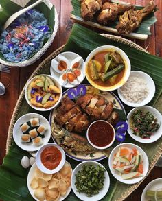 a table topped with lots of different types of food and bowls filled with sauces