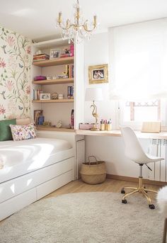 a bedroom with a bed, desk and chair in it next to a wallpapered wall