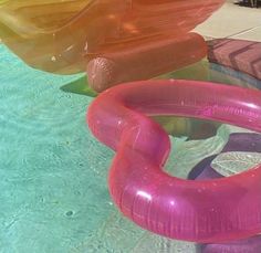 three inflatable boats floating on top of a swimming pool next to each other