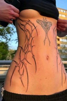 a woman with a butterfly tattoo on her stomach and side view of the lower body