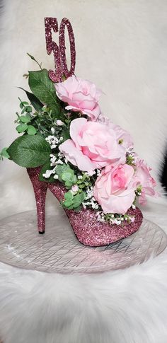 a pink glitter high heel shoe with flowers on it and the number 50 spelled out