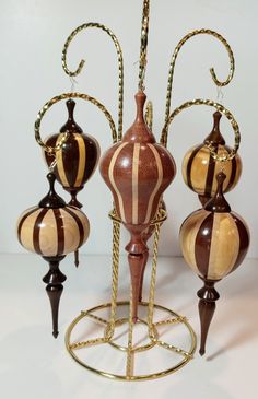 a set of three vases sitting on top of a stand