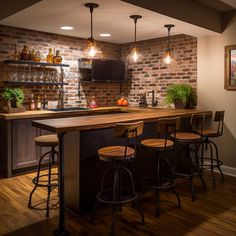 a kitchen with brick walls and wooden flooring, bar stools at the center