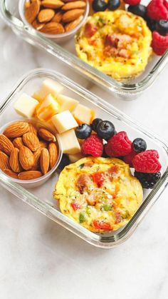 two plastic containers filled with food on top of a white counter next to each other