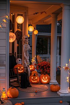 a porch decorated for halloween with pumpkins and jack - o'- lanterns