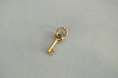 "14k Solid Gold Key Charm * Easy to add on chains * The perfect gift for anyone who has the key to your heart! Great for birthday gifts or anniversary presents! * Details * Key Size: 8.8mm x 4.2mm Material: 14k Solid Gold Marked: 14k on back of charm This is real 14k solid gold that is made to last! Please note that this listing is for the Charm ONLY. * Checkout more Gold Charm options here: https://etsy.me/3XIffzI Golden Drip 777 is a new Etsy shop offering some steep discounts (with more limit Classic Jewelry With Keys For Gifts, Gold Key, Key To My Heart, Key Pendant, Pendant Gold, Gift List, Pretty Jewellery, Buying Jewelry, Gold Charm