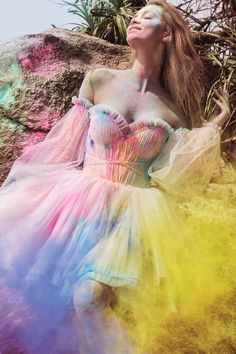 a woman in a dress covered in colored powder