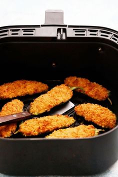 some fried food is being cooked in a pan