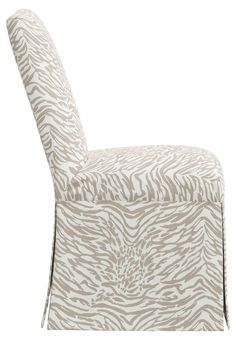 an upholstered chair with zebra print on the back and seat cover, in beige