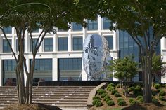 a building with stairs and trees in front of it