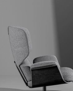 an upholstered chair and footstool are shown in this black and white photo