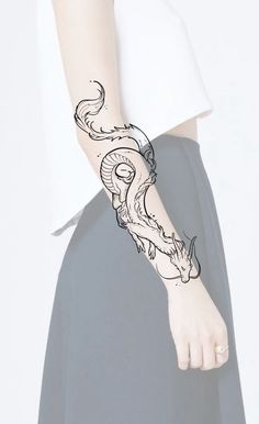 a woman's arm with a tattoo design on the left side of her arm