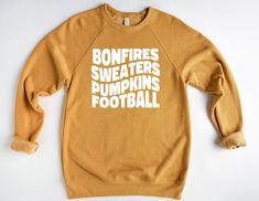 Bonfires, Sweaters, Pumpkins, Football - Sweater Weather - Fall Sweatshirt - Fall Crewneck - Comfy Sweatshirt - Custom Shirt - Football Sweatshirt - Bella Canvas Sweatshirt This item is handmade!  SIZING:  Sweatshirts are Bella + Canvas Unisex and super soft! They run true to size. Please check the sizing guide before ordering.  COLORS: Colors may vary slightly from computer/device.  WASH & CARE: For your sweatshirt to stay in tip-top shape the longest, it is best to wash shirt inside out and ha Crew Neck T-shirt For Game Day In Fall, Fall Short Sleeve Sweatshirt With Text Print, Short Sleeve Sweatshirt With Text Print For Fall, Fall Text Print Short Sleeve Sweatshirt, Fall Team Spirit Sweatshirt With Screen Print, White Screen Print Sweater For Fall, Fall Fan Apparel Sweatshirt With Text Print, Fall Crew Neck Screen Print Tops, Screen Print Crew Top For Fall