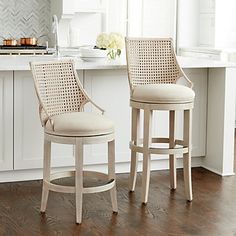 two stools sitting in front of a kitchen counter