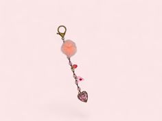 a keychain with a pom - pom hanging from it's side