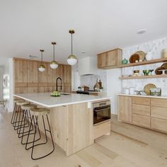 a kitchen with wooden cabinets and white counter tops