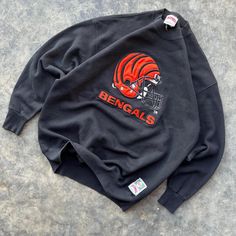 Vintage 90's NFL Football Cincinnati Bengals  Nutmeg Embroidered Crewneck Sweatshirt  Made in USA  23x29 Size XL approximately  Overall good vintage shape Rare Bengals Find  Excellent Embroidery Any questions feel free to reach out! Bengals Outfit Woman, 90s Style Crew Neck Sweatshirt With Embroidered Graphics, Vintage Embroidered Logo Crew Neck Top, Vintage Crew Neck Top With Embroidered Logo, 90s Style Winter Sweatshirt With Embroidered Graphics, 90s Embroidered Winter Tops, 90s Embroidered Top For Streetwear, Vintage Embroidered Sweatshirt For Streetwear, Retro Tops With Embroidered Graphics For Winter