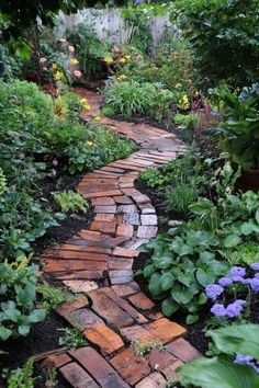 a brick path in the middle of a garden