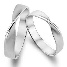 two white gold wedding rings on a white background