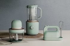 three different types of kitchen appliances sitting on a counter top, including a blender and mixer