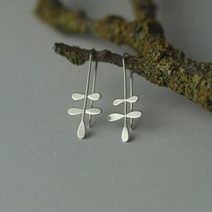 Inspired by fern leaves, these earrings make a lovely gift for a nature lover. Handmade by cutting small leaf shapes out of sterling silver sheet, recycling the remnants of cut outs of larger silver forms, soldering those onto a sterling silver wire to form the fern like structure. The silver wire is then bent into shape to form the ear threaders. The earring height is 4cm. The earrings take between 3 days to 7 days before posting. The earrings are sent to the recipient in a gift wrapped box. UK Nature Jewellery, Leaf Jewellery, Fern Earrings, Fold Forming, Earring Inspo, Plant Earrings, Oxidised Silver Jewelry, Handmade Silver Jewellery, Metalsmithing Jewelry