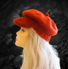 a mannequin head with a red hat on it's head and black background