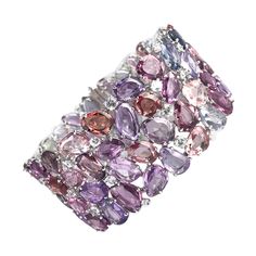 (DiamondTown) This stunning bracelet features 96.05 carats multicolor sapphires. The sapphire colors are various shades of pink, purple, green, blue, yellow, and peach, with 51 white sapphires in the mix as well. 28 round diamonds (total weight 0.44 carats) form the outside border of the bracelet at the clasp. The bracelet measures 7" and is set in 18k White Gold. Item details: 90 multicolor sapphires total 92.24 carats 51 round white sapphires total 3.81 carats 28 round white diamonds total 0.4 White Gold Diamond Bracelet, Cameo Bracelet, Modern Bracelets, Diamond Bangles Bracelet, Bracelets Gold Diamond, White Gold Bracelet, Sapphire Color, Diamond Bangle, Lovely Jewellery