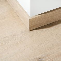 a close up view of a wood floor with white paint on the top and bottom