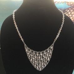 "This is a fabulous small bib necklace, designed and made by us using upcycled products. We incorporated a gothic chainmail look accented with rhinestones. The chainmail base has an aged patina in a wonderful design accented with rhinestones. All rhinestones are bright. Overall measures 22\" and can be adjusted.The chainmail bib measures 4\" x 3\". Great for costume or stage exudes a beautiful almost animated sparkle. Perfect for any unique jewelry lover and one of a kind! Please zoom onto photo Luxury Metal Chainmail Necklace, Metal Chainmail Necklace For Party, Silver Rhinestone Necklace With Adjustable Chain, Party Chainmail Metal Necklace, Metal Rhinestone Necklace With Chain For Evening, Silver Beaded Rhinestone Necklace In Metal, Metal Chain Bib Necklace Gift, Silver Beaded Rhinestone Necklace, Metal Chain Bib Necklace For Gift