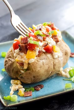 a fork digging into a loaded baked potato